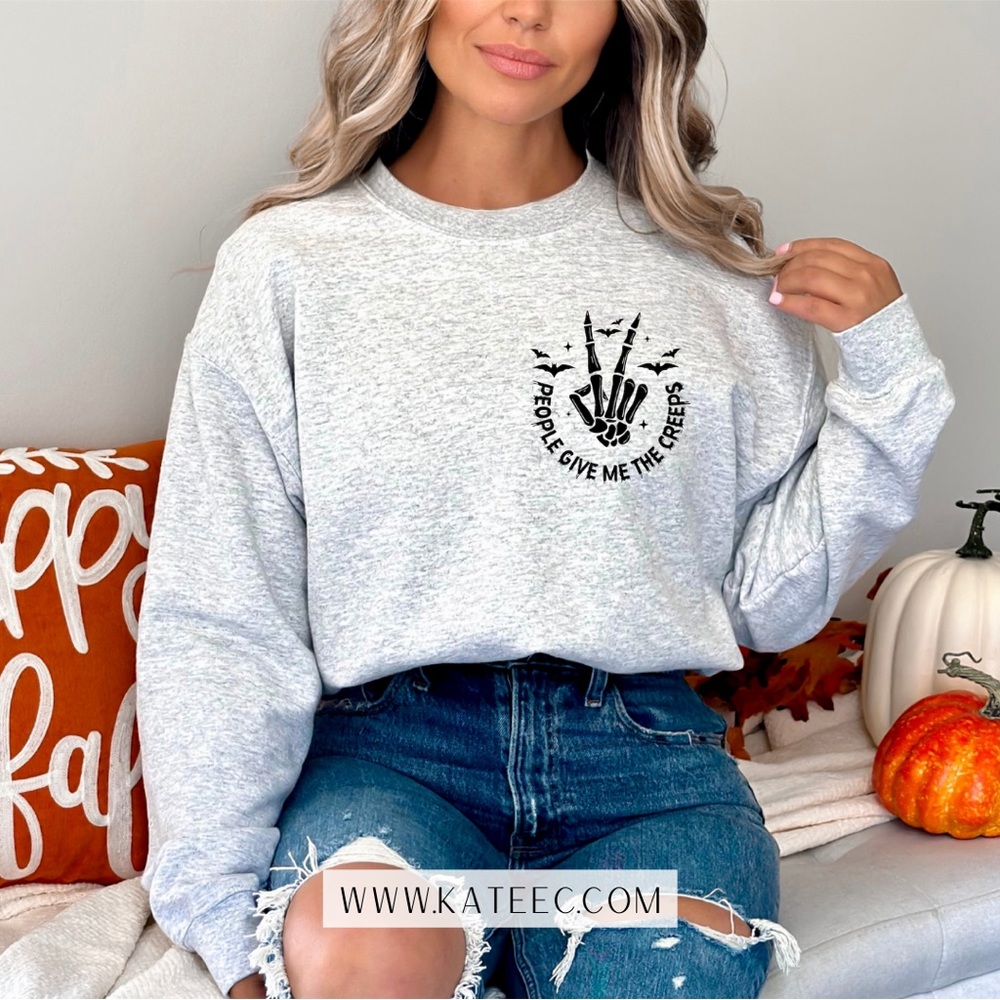 Trendy Halloween graphic design on the softest crew neck sweater in your closet!